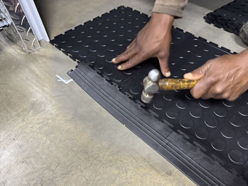 Dura Tile PVC interlocking floor tiles being fitted with a mallet