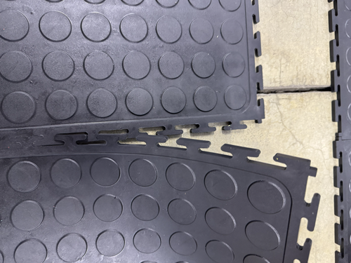 Dura Tile interlocking floor tiles being prepared for adhesive application
