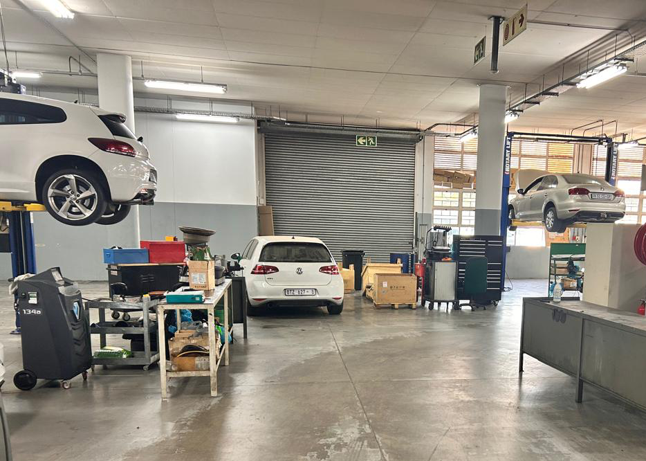 Commercial vehicle garage with worn concrete floor before Dura Tile installation