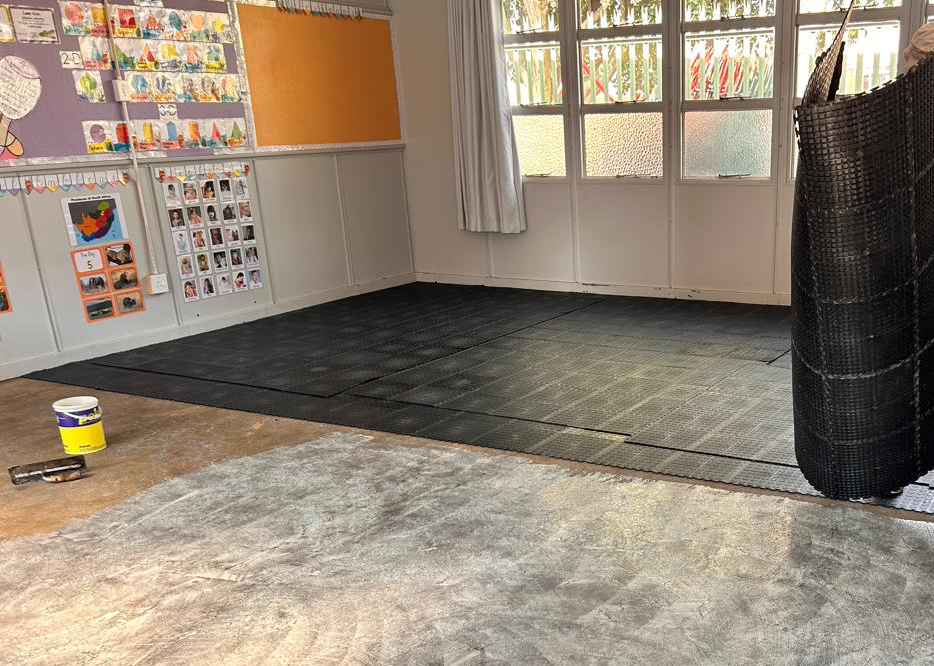 Dura Tiles being installed in a classroom to replace worn carpeting