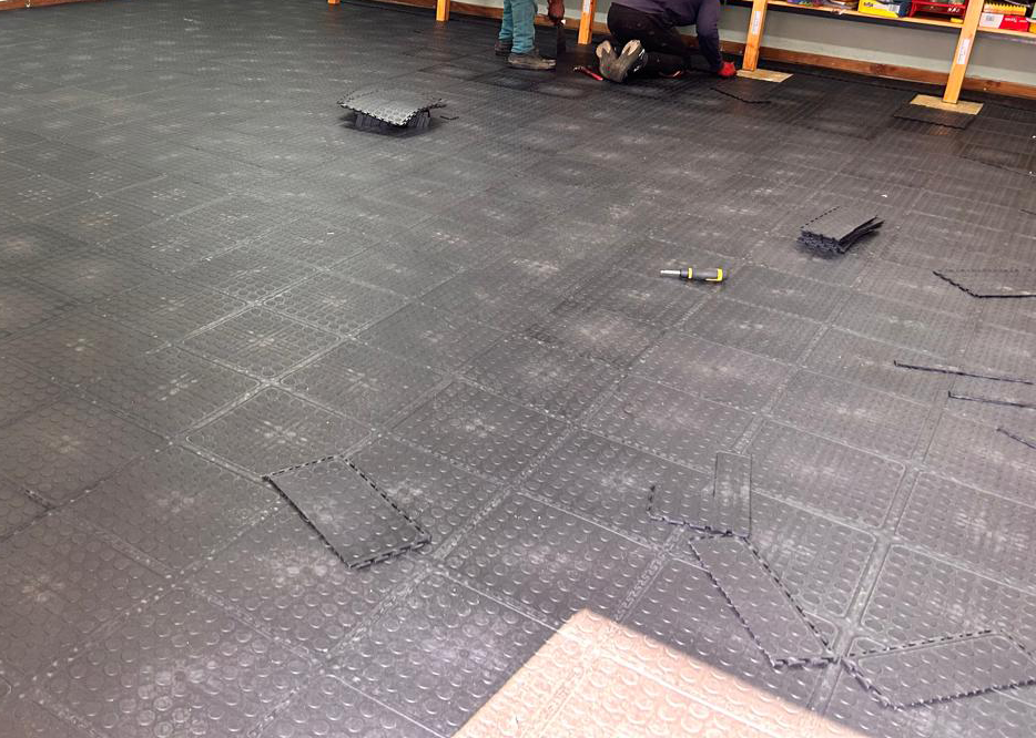 Dura Tile interlocking flooring being installed across a classroom floor