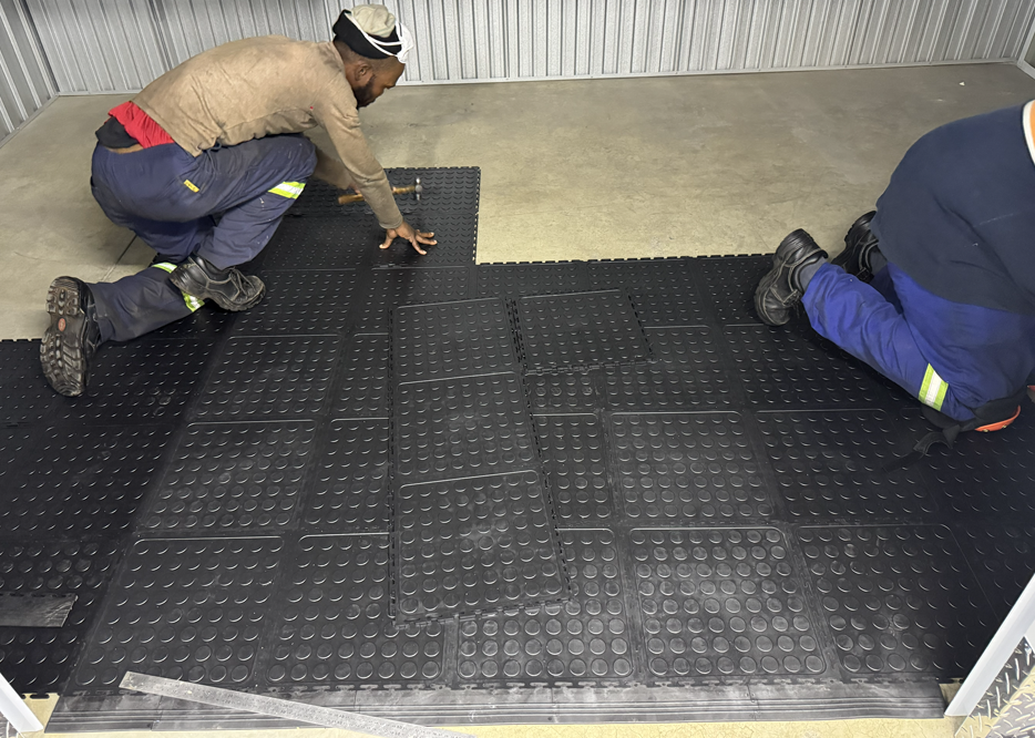 Dura Tiles being installed over a concrete floor in a self storage unit